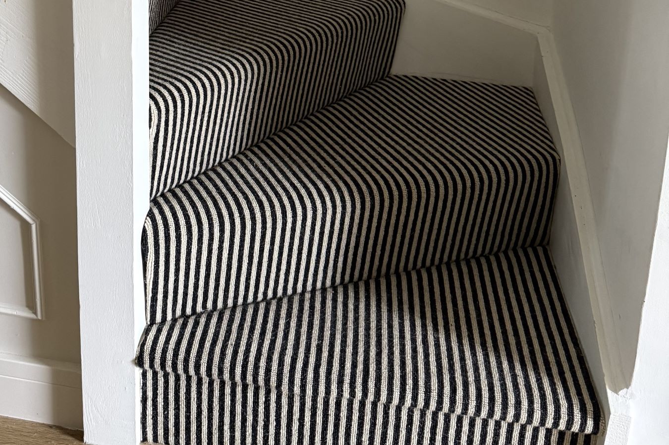 black and white cream striped stairs carpet on curved staircase